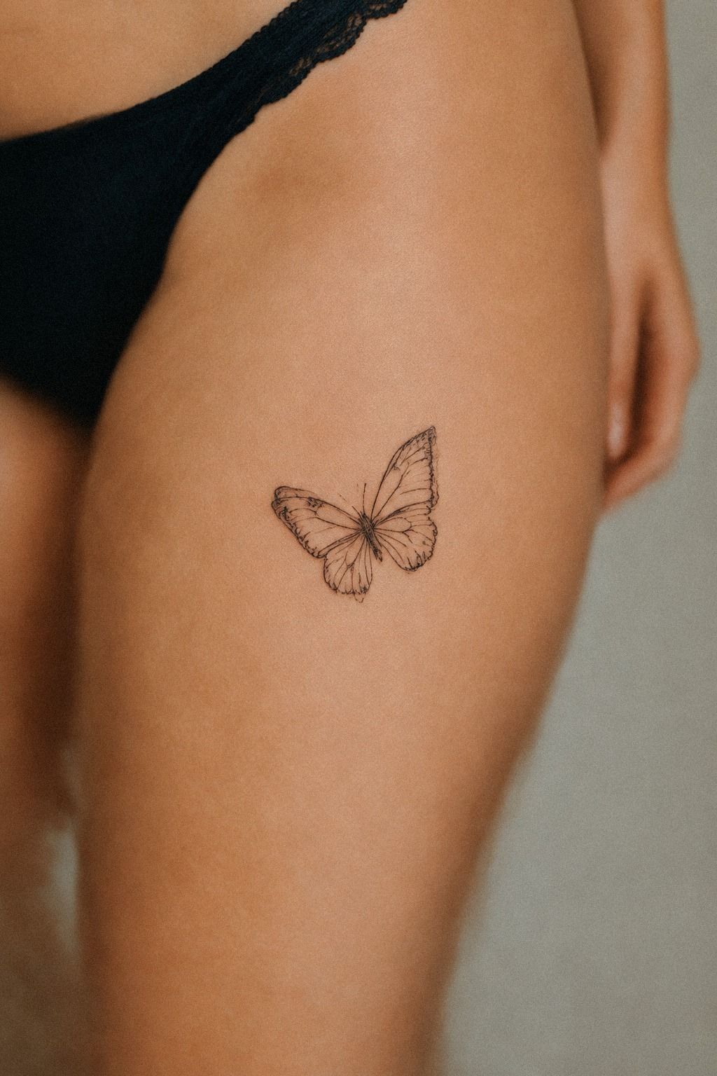 Delicate Small Butterfly Tattoo Behind the Ear