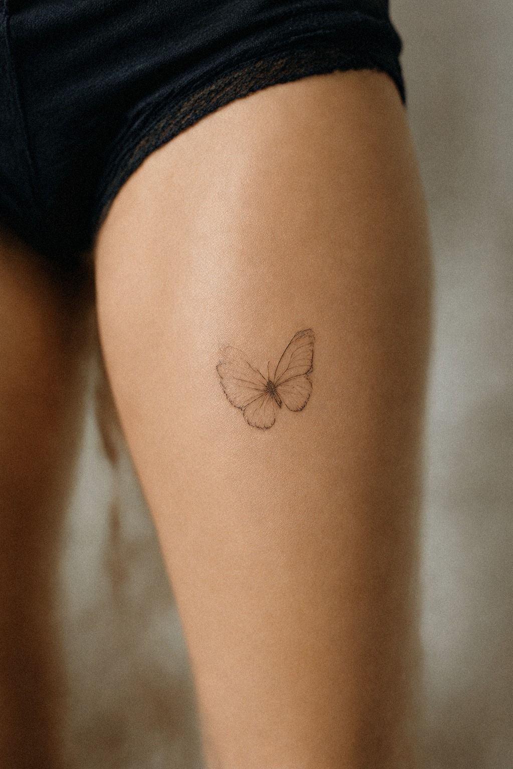 Delicate Small Butterfly Tattoo on the Collarbone